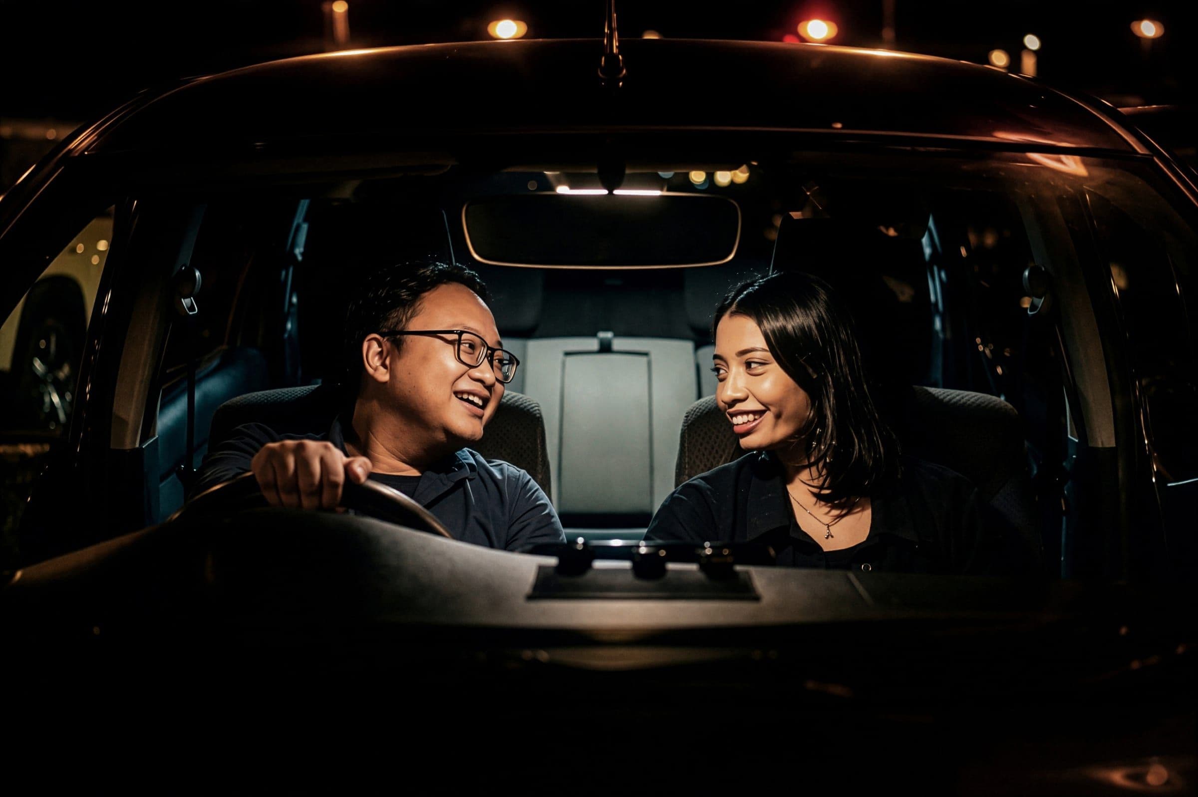 Sandra and Nandra sharing a quiet moment in the car at night